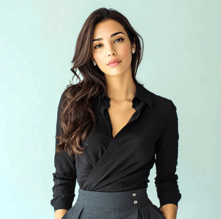 Model wearing a stylish black blouse paired with a gray skirt, showcasing elegance and confidence.