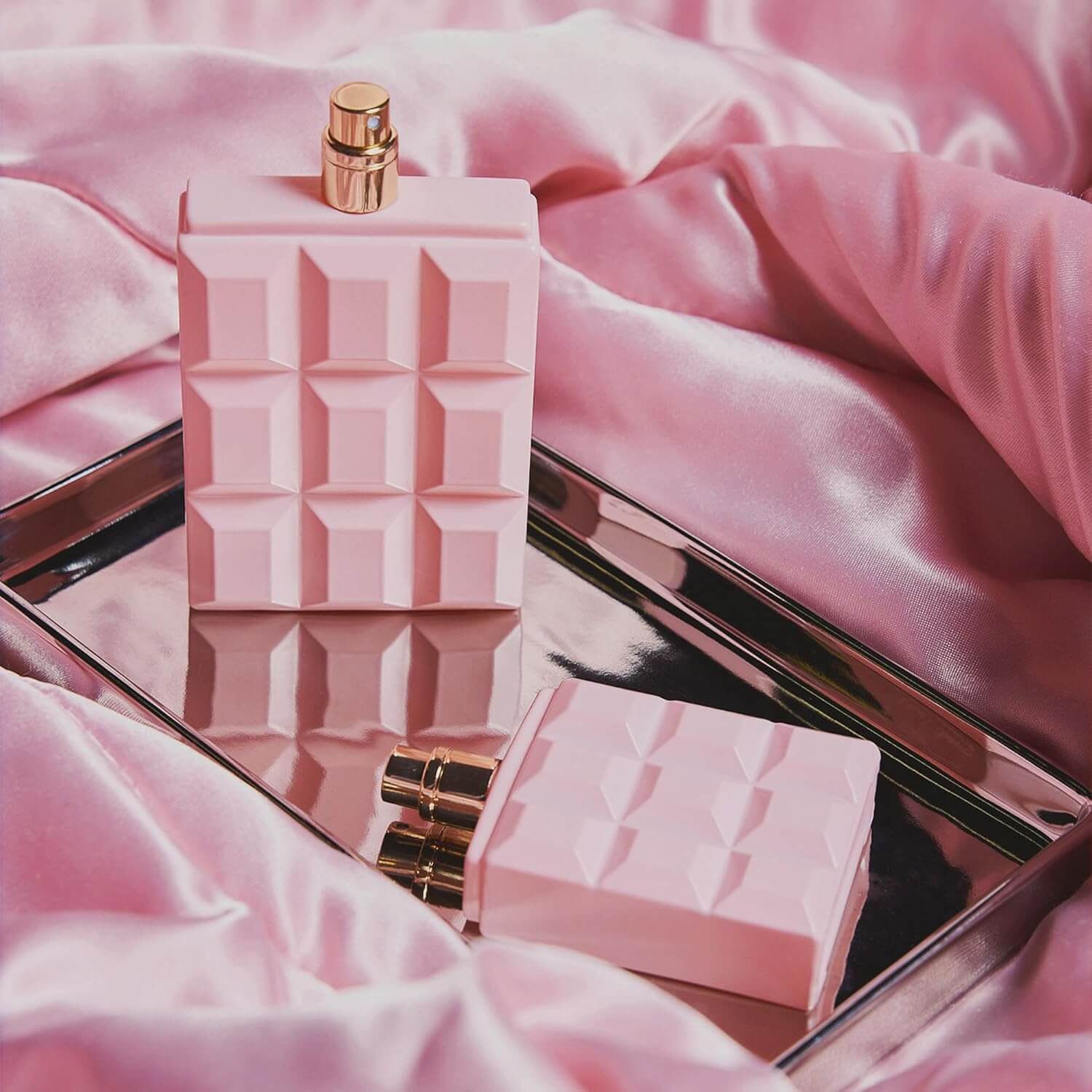 Revibe Zen Aroma Elegance perfume displayed on a silver tray with pink silk fabric.